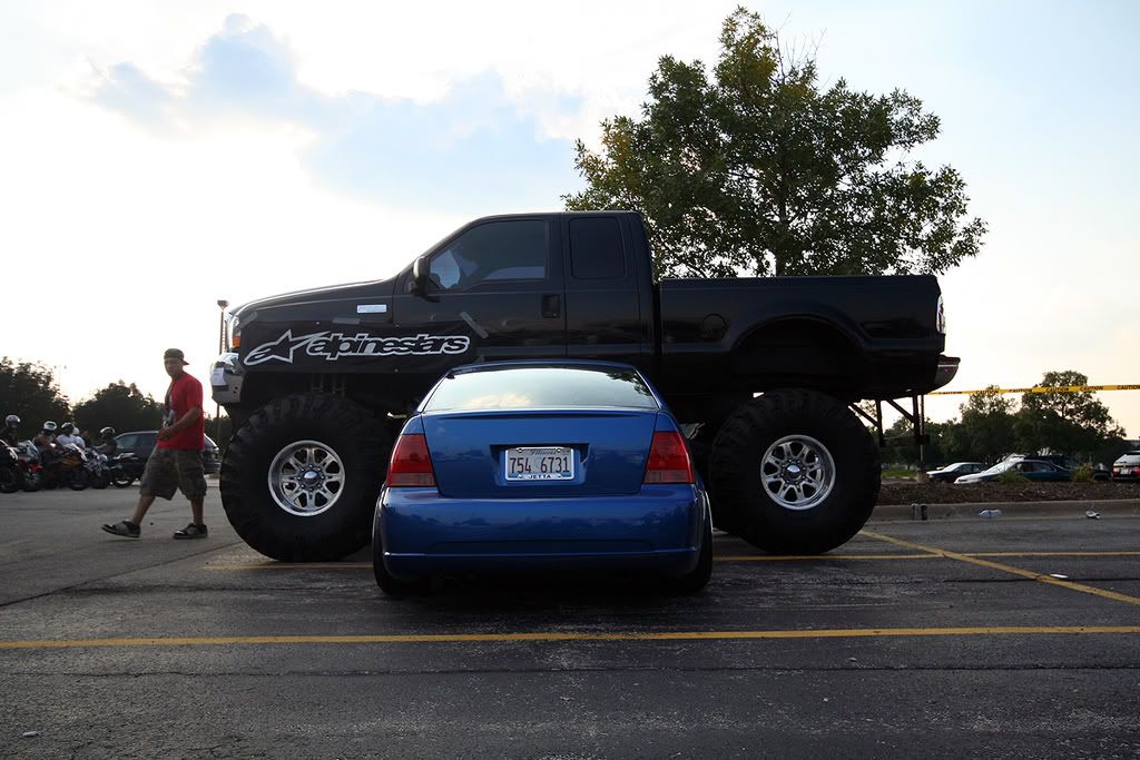 Picture of slammed mk4 next to a rasied truck
